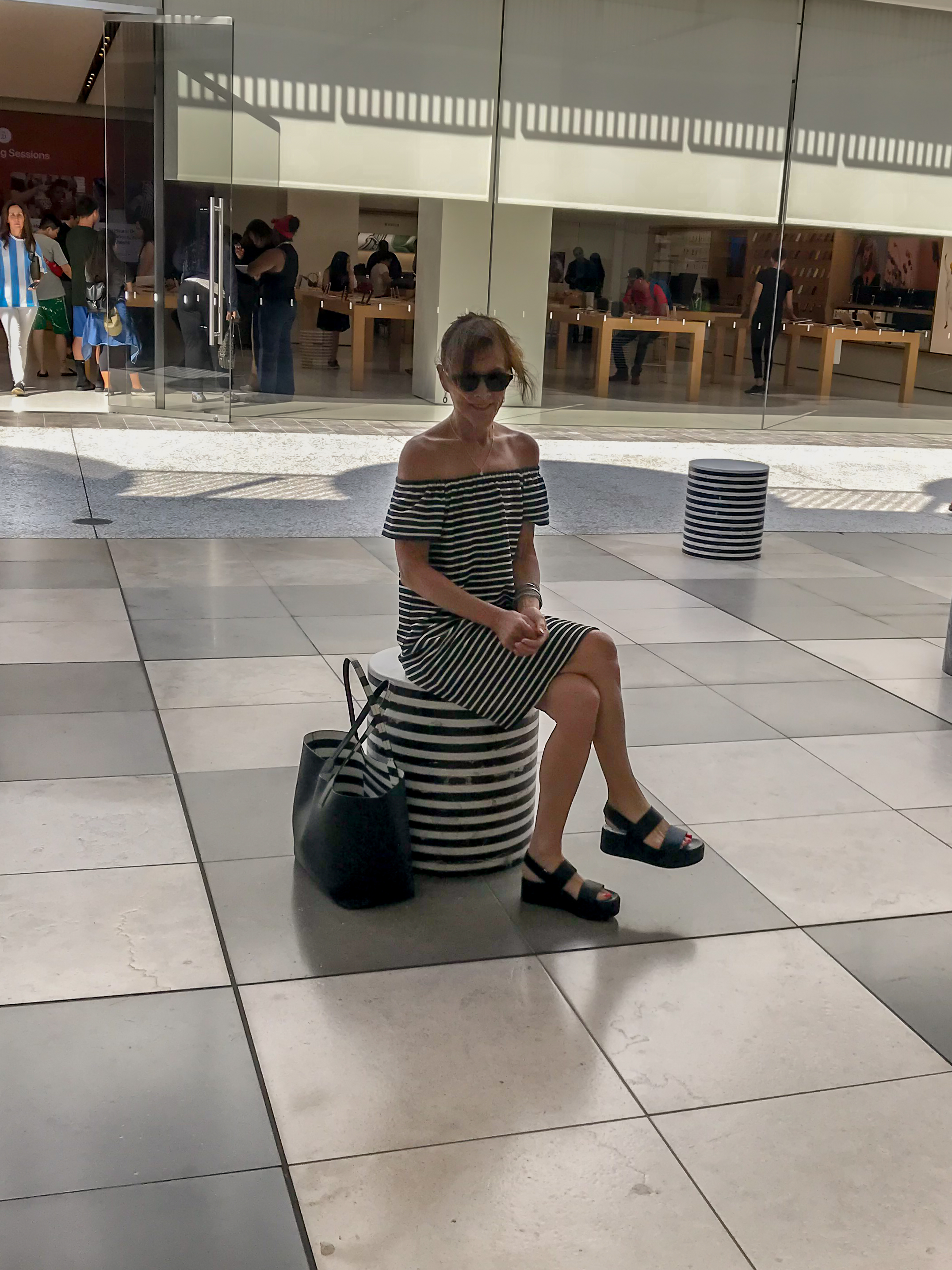 Woman sitting at the Westfield Century City Mall