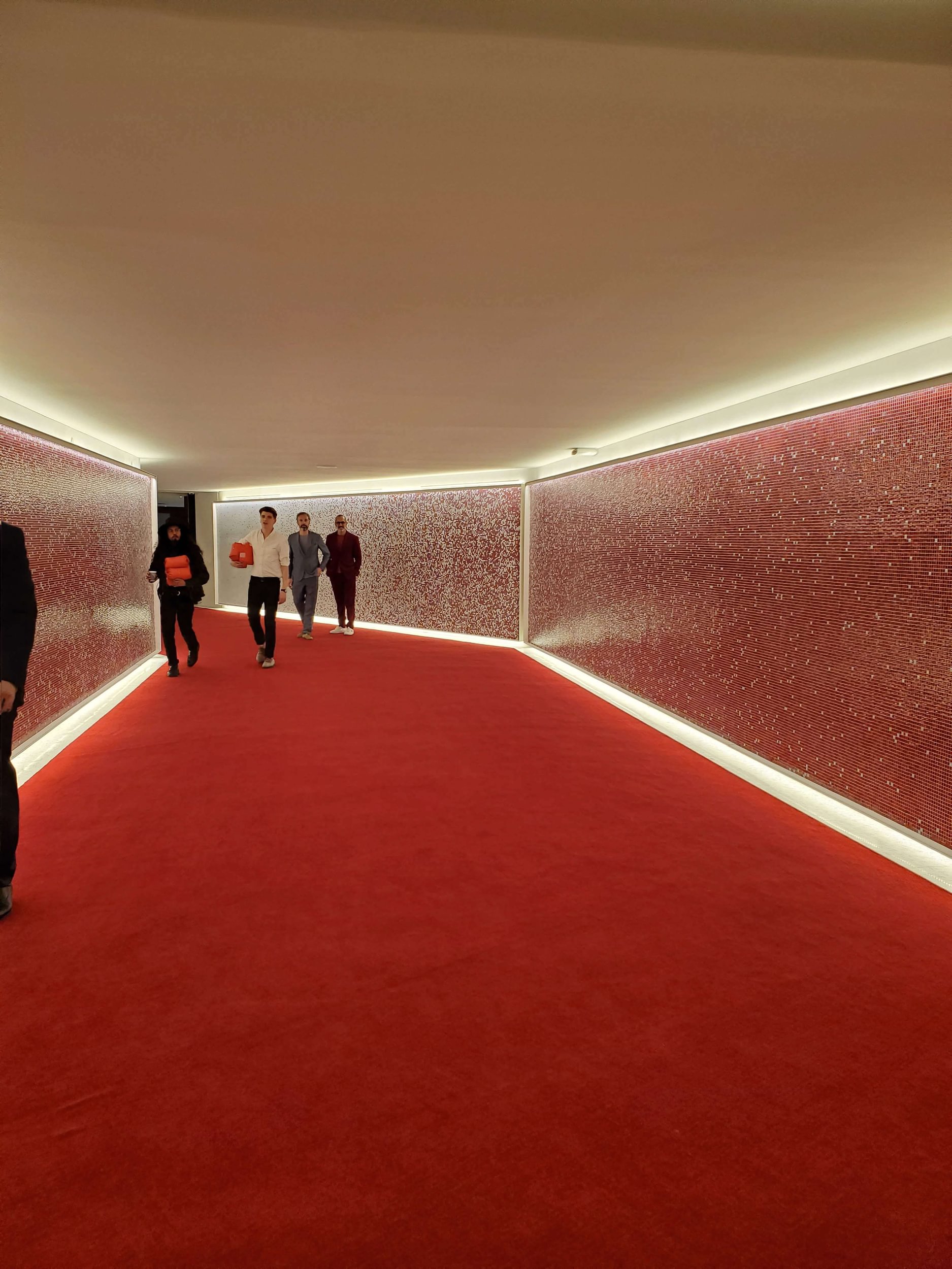 Red Tile mosaic walls in a long hallway