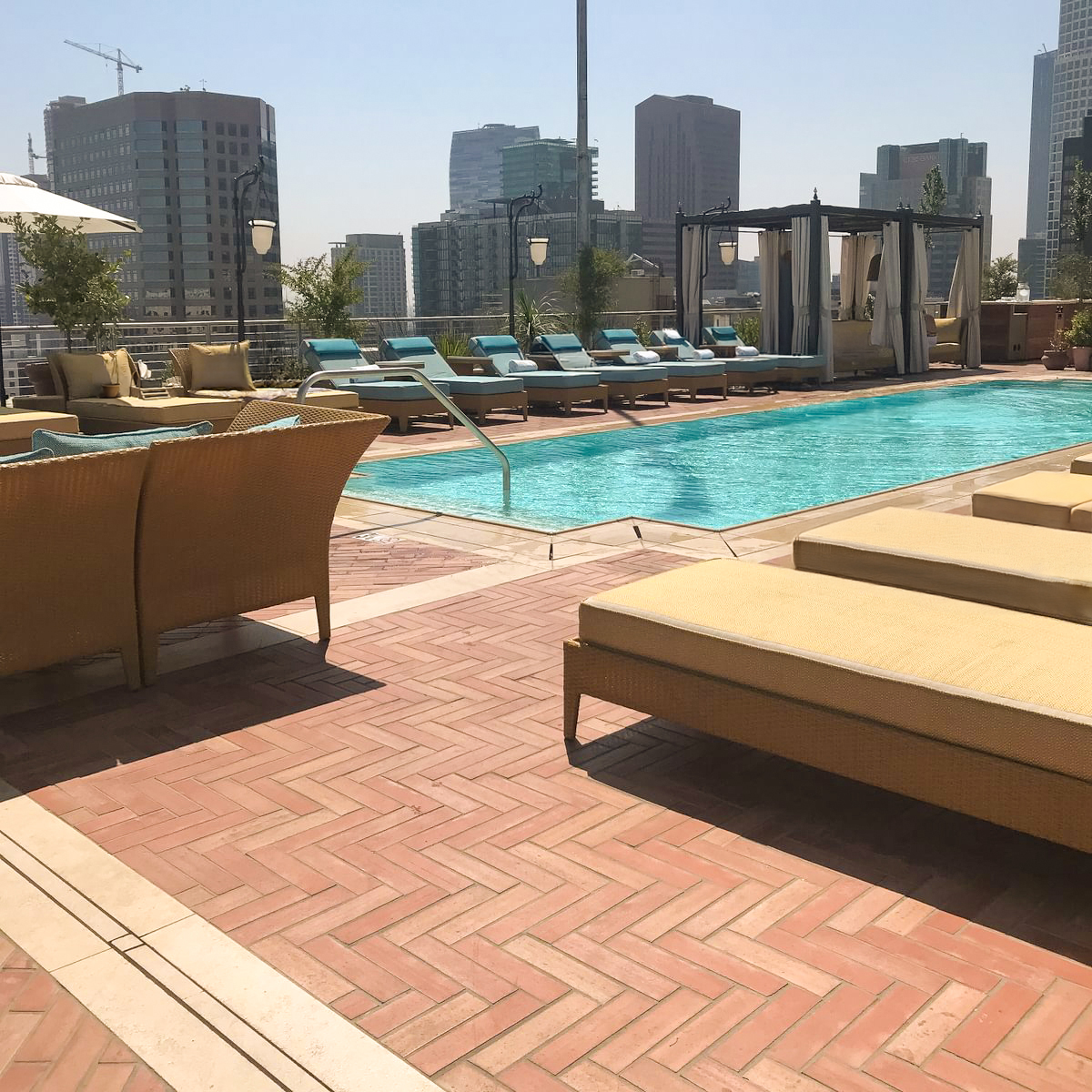 NoMad Hotel Los Angeles showcases Enrico Macchina Terracotta - Wire Cut tiles in a bold herringbone pattern at their rooftop poolside patio. Supplied by DDS Tile & Stone